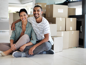 Couple sitting in front of moving boxes